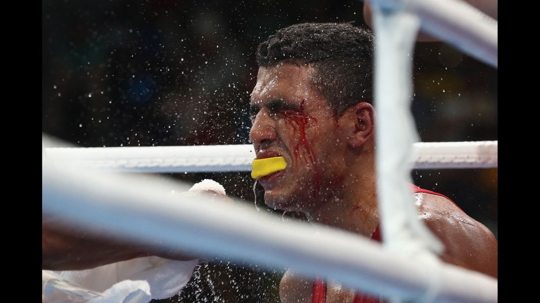 The trainer of Moroccan boxer Mohammed Rabil sprays water onto Rabil's face during his welterweight bout against Uzbekistan's Shakhram Giyasov. Giyasov won to advance to the final.