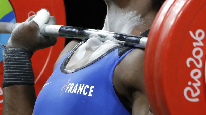 A barbell rests on the collarbones of French weightlifter Gaelle Nayo-Ketchanke as she performs a clean-and-jerk lift on Friday, August 12.