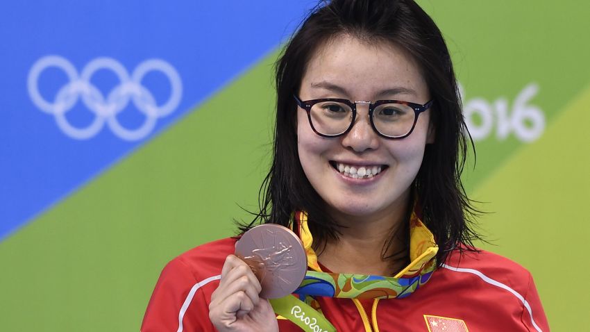 China's Fu Yuanhui poses with her bronze medal on the podium of the Women's 100m Backstroke during the swimming event at the Rio 2016 Olympic Games at the Olympic Aquatics Stadium in Rio de Janeiro on August 8, 2016.   / AFP / GABRIEL BOUYS        (Photo credit should read GABRIEL BOUYS/AFP/Getty Images)