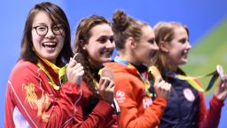 Hungary's Katinka Hosszu (2ndR) celebrates with silver medallist USA's Kathleen Baker (R) and equal bronze medallists Canada's Kylie Masse (2ndL) and Chinese's Fu Yuanhui on the podium after she won the Women's 100m Backstroke Final during the swimming event at the Rio 2016 Olympic Games at the Olympic Aquatics Stadium in Rio de Janeiro on August 8, 2016.   / AFP / CHRISTOPHE SIMON        (Photo credit should read CHRISTOPHE SIMON/AFP/Getty Images)