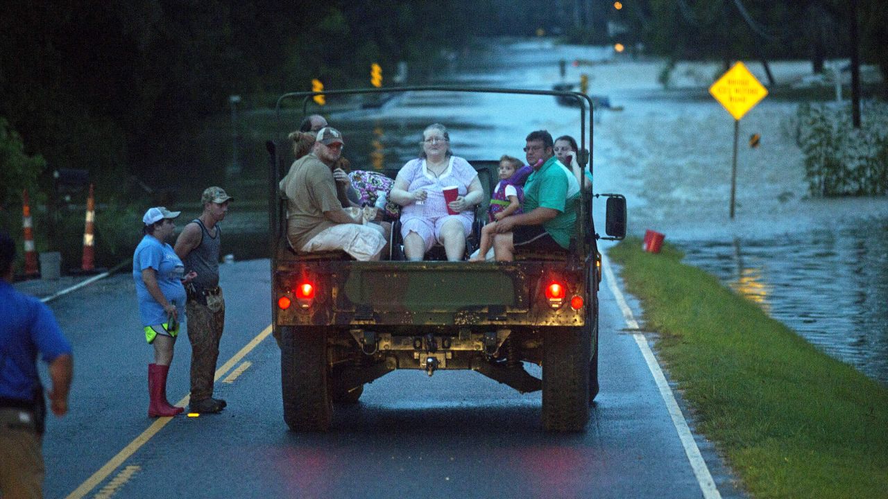 Emergency personnel rescue flood victims near Walker on August 14.
