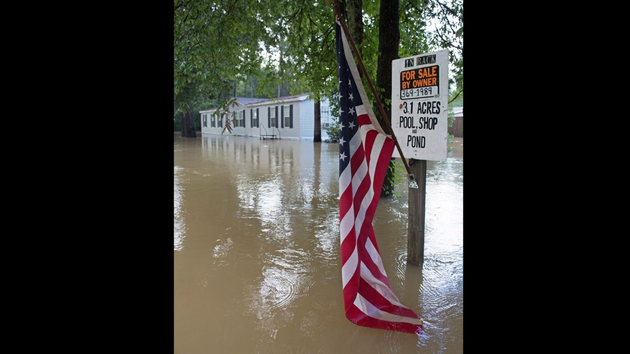 An American flag hangs in floodwaters in Walker on August 15.
