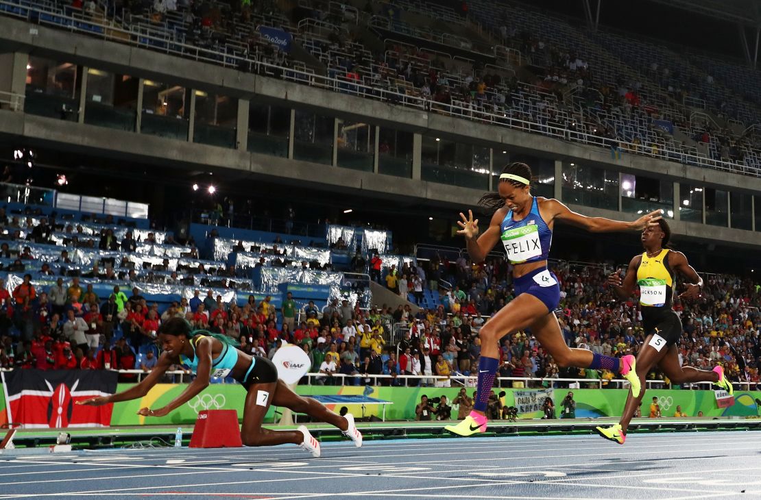 Shaunae Miller dives over the finish line to win the gold medal in the women's 400-meter final ahead of  Allyson Felix of the United States.