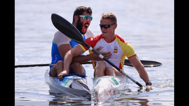 Canoeist Josef Dostal of the Czech Republic, left, celebrates with Spain's Marcus Walz after the K-1 1,000-meter final. Walz and Dostal took gold and silver while Russia's Roman Anoshkin earned the bronze.