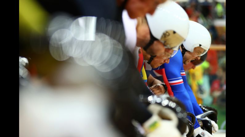 Track cyclists prepare to compete in the first round of the keirin.