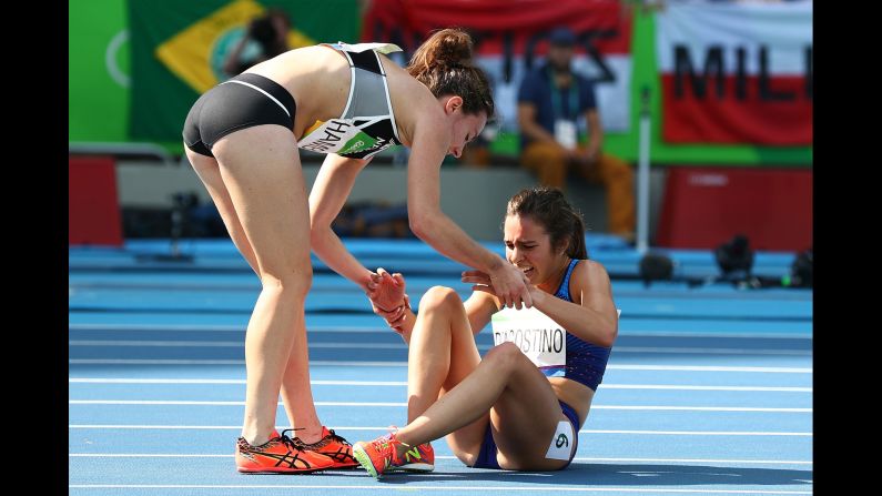 New Zealand's Nikki Hamblin, left, helps Abbey D'Agostino of the United States <a href="index.php?page=&url=http%3A%2F%2Fwww.nbcolympics.com%2Fvideo%2Fus-runner-finishes-race-after-falling-hard" target="_blank" target="_blank">after they collided</a> during the 5,000-meter semifinal. Both runners managed to finish the race.