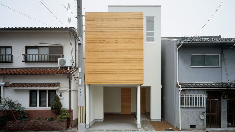 Designed by Ido Kenji Architectural Studio, House F was built on a narrow plot of land for a couple in Osaka. The three-story house incorporates warm pine wood, large windows, and a garden on the south side. 