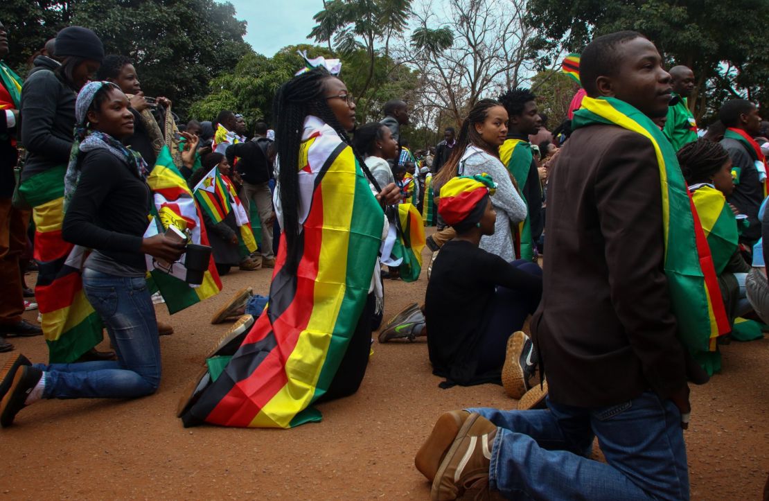 Supporters of the ThisFlag campaign kneel outside the Harare magistrate's court where pastor Evan Mawarire appeared on July 13.