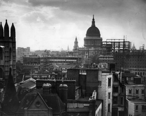 London's skyline was irrevocably altered by bombing in the Second World War. Many of the remaining historical buildings became protected -- but whole areas were wiped out and needed to be rebuilt. This image depicts St Paul's post-war reconstruction being carried out in London after the war.  