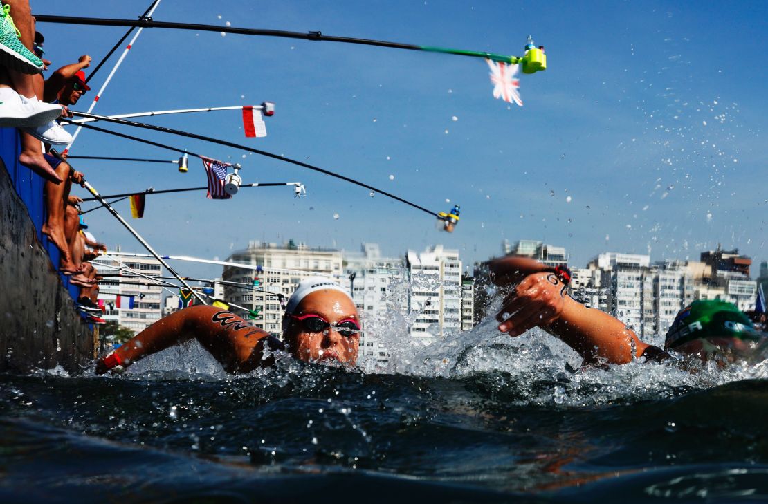 Aurelie Muller of France takes on refreshments during the Women's 10km Marathon Swim.