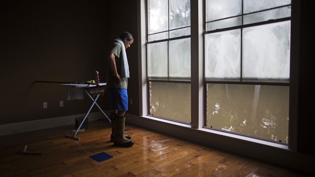 David Key looks outside his flooded home in Prairieville on Tuesday, August 16.