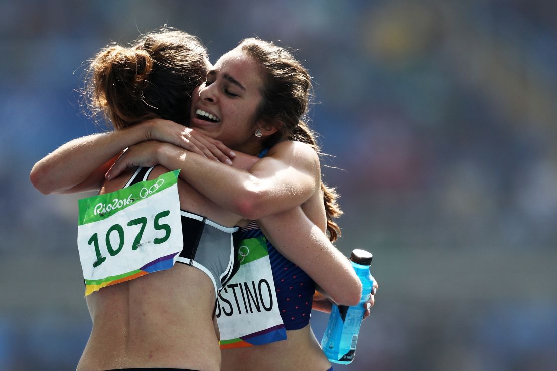 Abbey D'Agostino of the US (R) hugs New Zealand's Nikki Hamblin after the women's 5000m heats.