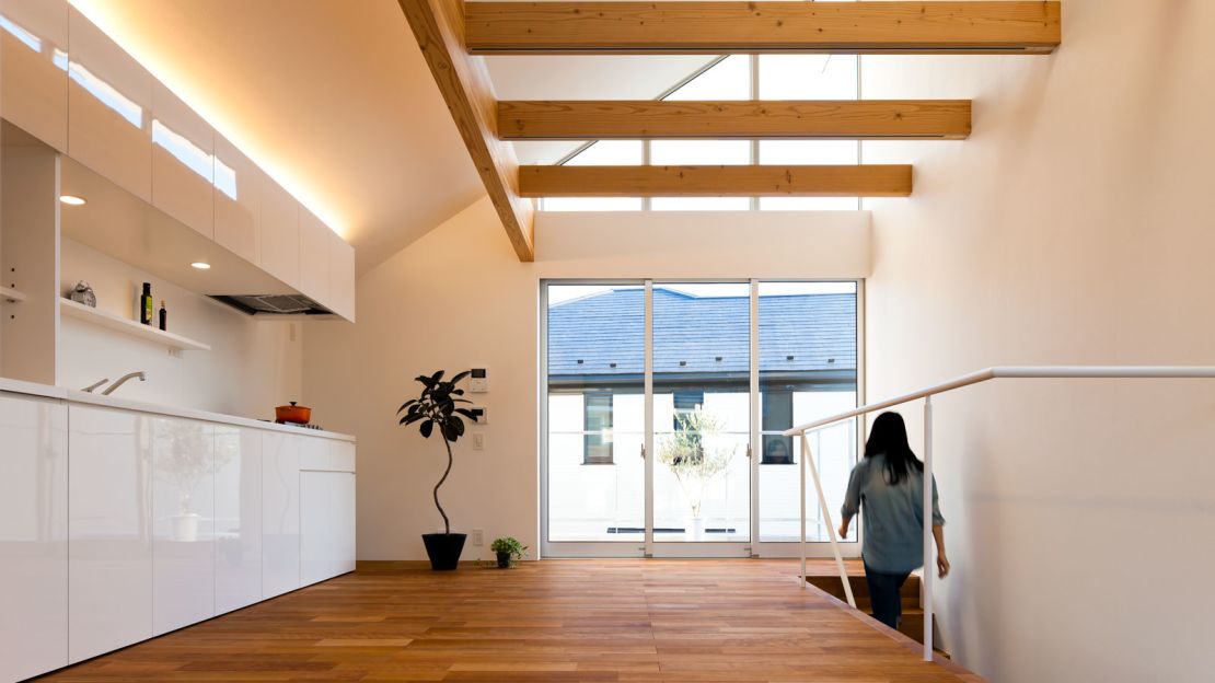 Inside Atelier Tekuto's M House, everything has its place. The uncluttered space feels spacious and large, an effect that's accentuated by floor-to-ceiling windows.