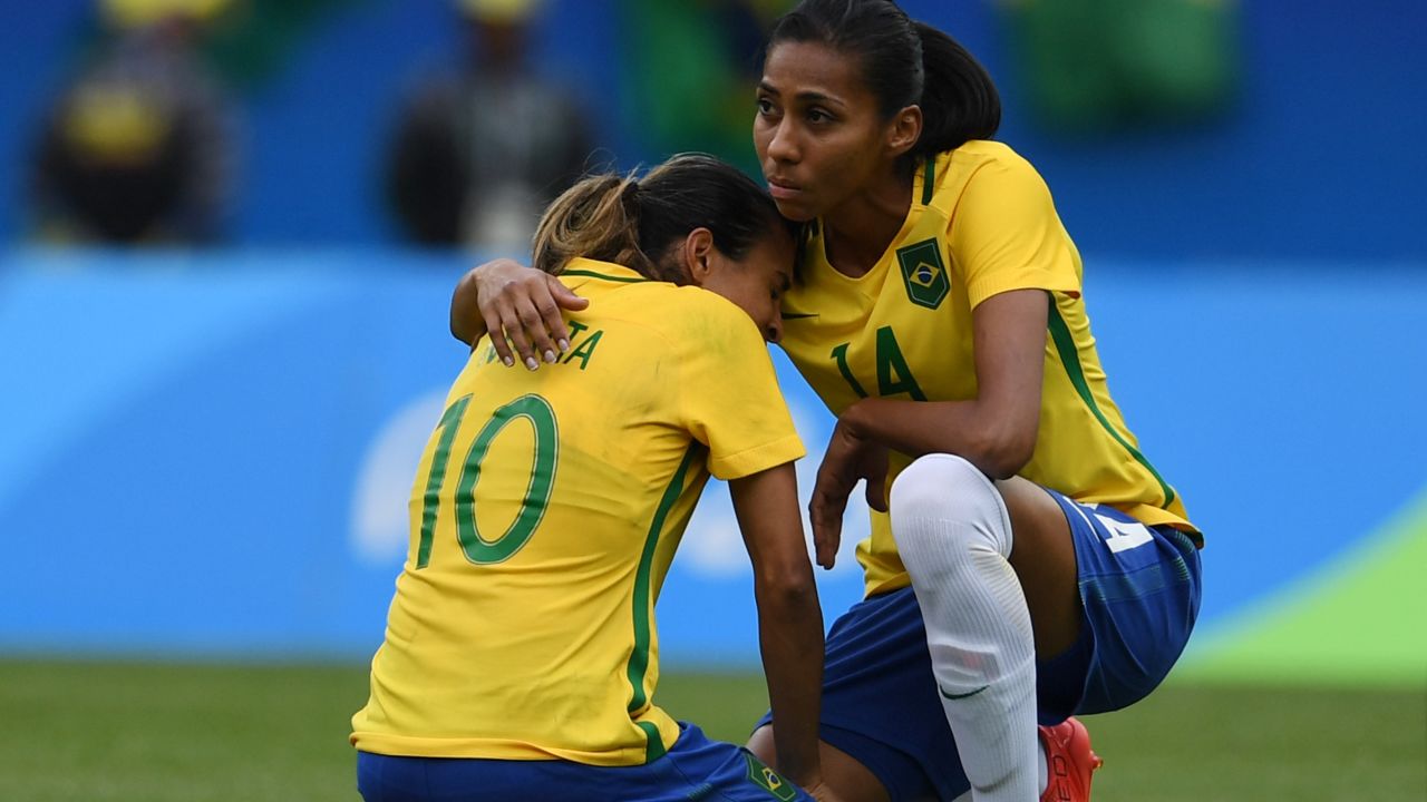 Marta is consoled by teammate Bruna after Sweden knocks Brazil out of the Olympic football tournament.