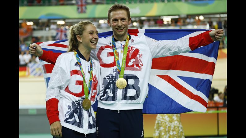 Great Britain's Laura Trott and her fiance, Jason Kenny, pose with their gold medals in track cycling. Kenny won the keirin and Trott won the omnium.