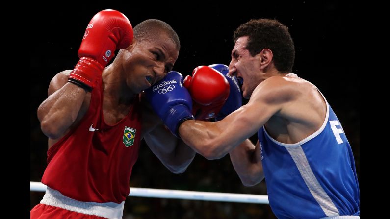 Brazil's Robson Conceicao, left, boxes France's Sofiane Oumiha in the lightweight final. Conceicao won the bout to earn the host country its first-ever gold medal in boxing.
