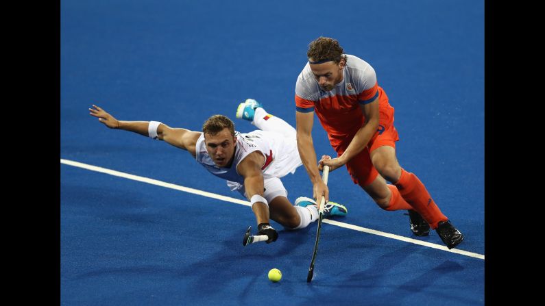 Dutch field hockey player Bob de Voogd, right, is challenged by Belgium's Emmanuel Stockbroekx during a semifinal match. Belgium won 3-1 to advance to the final against Argentina.