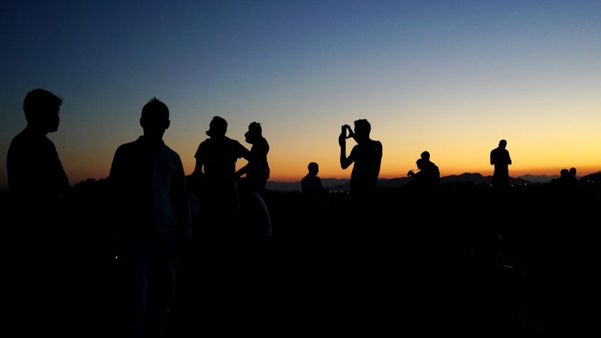 Tourists visit the Areios Pagos hill in Athens on August 15, 2016. / AFP / Angelos Tzortzinis        (Photo credit should read ANGELOS TZORTZINIS/AFP/Getty Images)