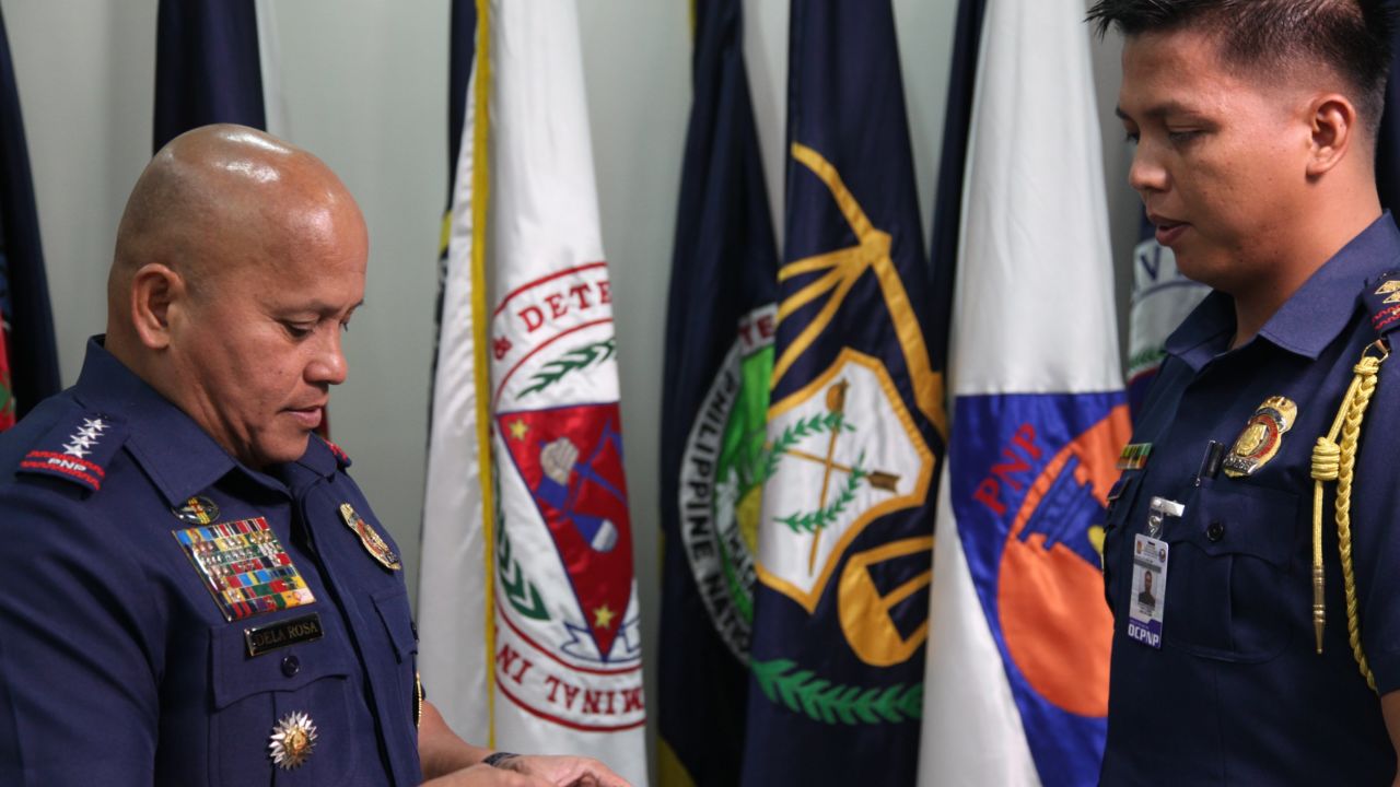  Ronald Dela Rosa speaks to one of his officers in his office at the police headquarters in Camp Crame, Quezon City. 