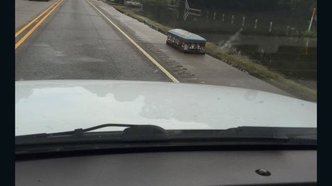 A casket sits on a road in Baton Rouge after getting washed out in flooding.