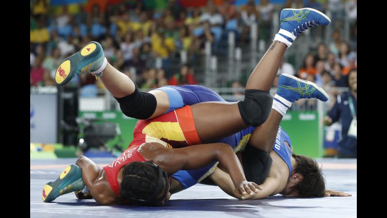 Brazilian freestyle wrestler Joice Silva, in red, competes against Kyrgyzstan's Aisuluu Tynybekova in a 58-kilogram (128-pound) qualification round.