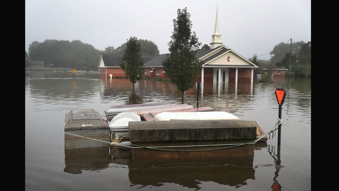Caskets float in floodwaters near a cemetery in Gonzales on August 17.