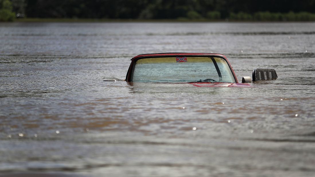 A pickup truck is partially submerged in Port Vincent, Louisiana, on August 16.