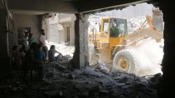 Syrians shelter in a damaged building as civil defence workers sift through debris looking for survivors following reported air strikes on July 14, 2016 in Aleppo's rebel-held neighbourhood of Tariq al-Bab. 
Nine people were killed in the Tariq al-Bab area, and another three in the district of Salhin, both in eastern Aleppo, the Syrian Observatory for Human Rights reported. The Britain-based group said it was unclear whether the strikes were carried out by warplanes of the Syrian government or its ally Russia.

 / AFP / THAER MOHAMMED        (Photo credit should read THAER MOHAMMED/AFP/Getty Images)