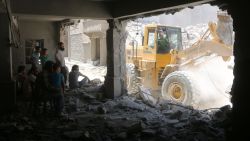 Syrians shelter in a damaged building as civil defence workers sift through debris looking for survivors following reported air strikes on July 14, 2016 in Aleppo's rebel-held neighbourhood of Tariq al-Bab. 
Nine people were killed in the Tariq al-Bab area, and another three in the district of Salhin, both in eastern Aleppo, the Syrian Observatory for Human Rights reported. The Britain-based group said it was unclear whether the strikes were carried out by warplanes of the Syrian government or its ally Russia.

 / AFP / THAER MOHAMMED        (Photo credit should read THAER MOHAMMED/AFP/Getty Images)
