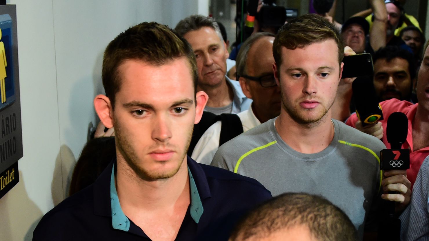 American swimmers Gunnar Bentz (left) and Jack Conger leave the police station at the Rio airport.