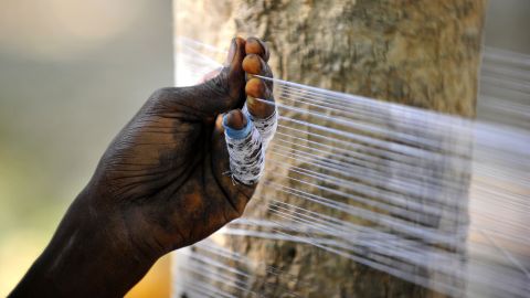 An Indian youth prepares "manja," a strong string coated with powdered glass or other abrasives and used to fly kites, in Allahabad on April 9, 2013.
