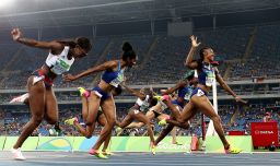 Brianna Rollins of the United States (R) wins the gold medal in the Women's 100m Hurdles Final in front of many empty seats.