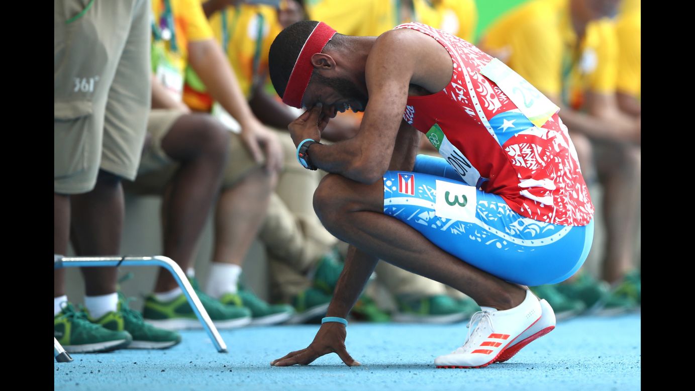 Puerto Rico's Javier Culson reacts after being disqualified in the 400-meter hurdles final.