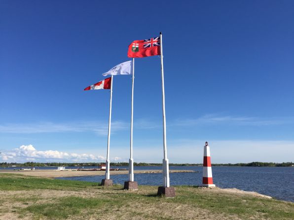 From left to right, the flags of Canada, Norway House Cree Nation, and the province of Manitoba.