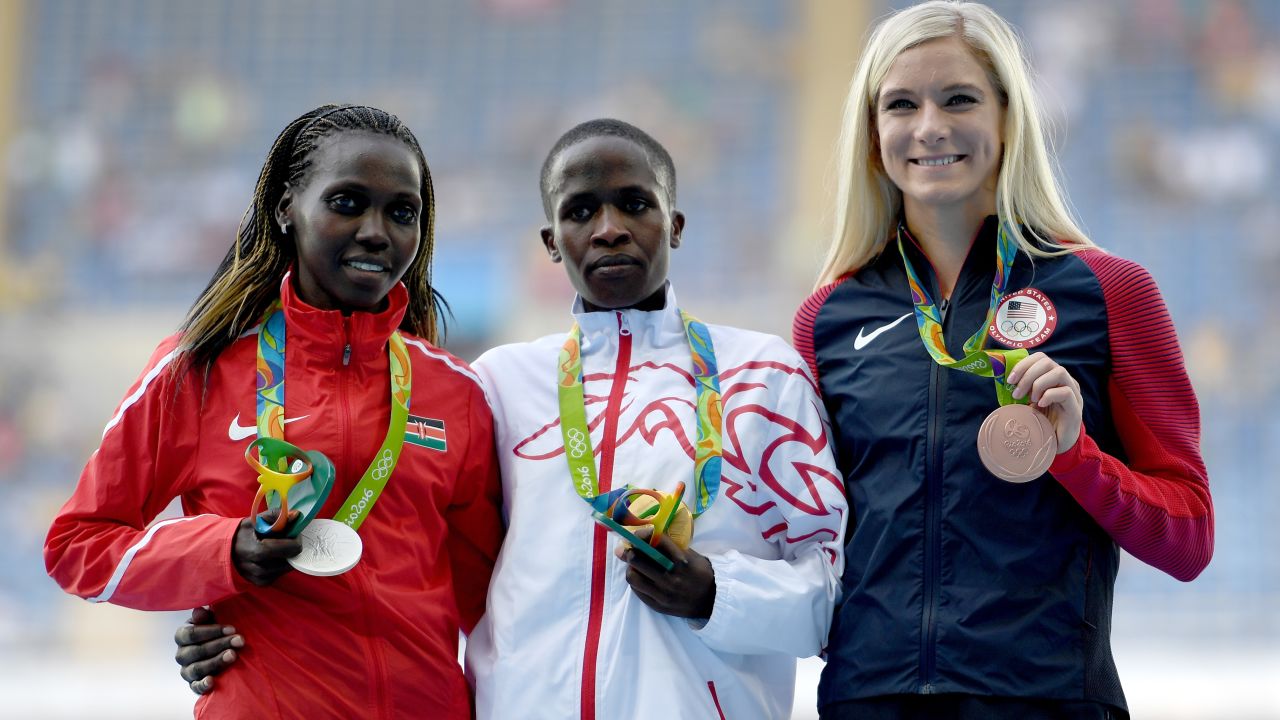 Ruth Jebet (center) of Bahrain poses with her  gold medal.