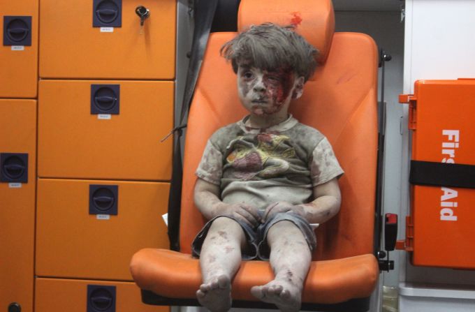 <strong>2016: Aleppo, Syria</strong> -- Five-year-old Omran Daqneesh waits shell-shocked in the back of an ambulance. He and other members of his family were injured when airstrikes ripped through his neighborhood in August. The photo <a href="index.php?page=&url=http%3A%2F%2Fwww.cnn.com%2F2016%2F08%2F17%2Fworld%2Fsyria-little-boy-airstrike-victim%2F" target="_blank">inspired international grief</a> and put a face on Syria's ongoing civil war. 