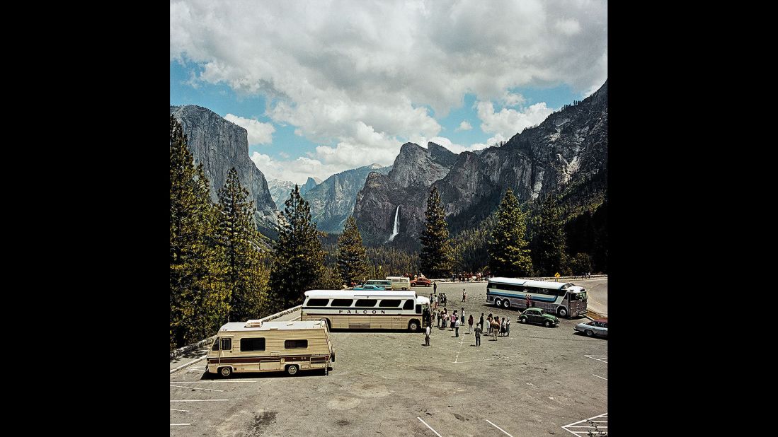 <em>Parking Lot at Inspiration Point, Yosemite National Park, California, 1980. </em>The trappings of tourism -- tour buses, motor homes, casual dress -- are part of what drew Minick to sightseeing.