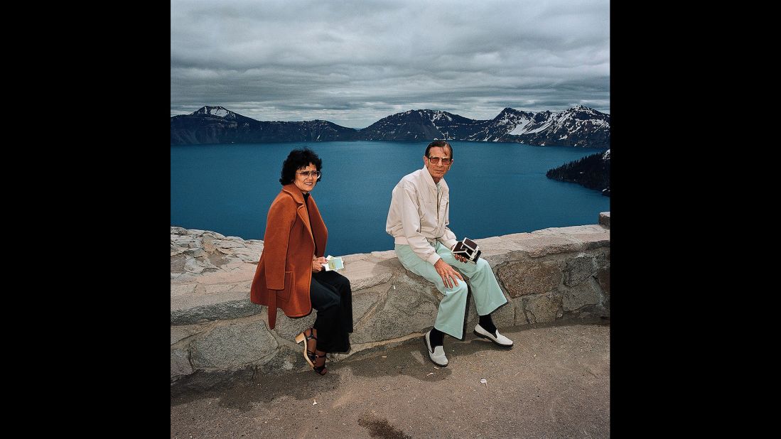 <em>Couple Taking Polaroids at Crater lake National Park, Oregon, 1980. </em>Minick often offered to take Polaroids of his subjects before he photographed them with his other camera. This couple had a Polaroid camera, too.