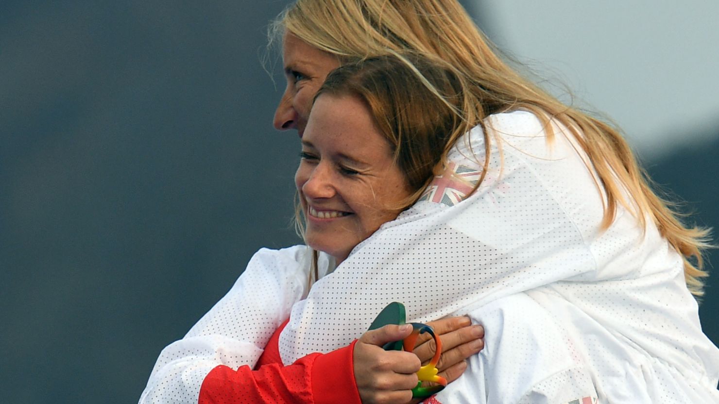 Gold medallists Britain's Hannah Mills and Saskia Clark celebrate on the podium at Rio 2016.