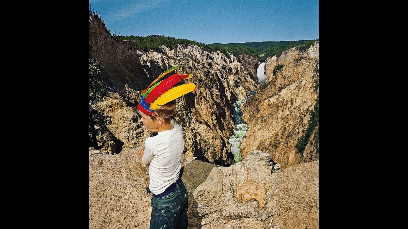 <em>Boy with Feathered Headress at Lower Falls Overlook, Yellowstone National Park, 1980. </em>Minick spent time at hundreds of overlooks, scouting for visually arresting combinations of people and scenery.