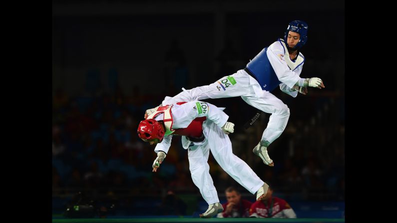 Russia's Alexey Denisenko kicks Belgium's Jaouad Achab during a taekwondo semifinal. Denisenko ended up with the silver medal.