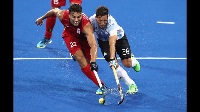 Belgium's Simon Gougnard, left, is challenged by Argentina's Agustin Mazzilli during the field hockey final. Argentina won the gold medal with a 4-2 victory.