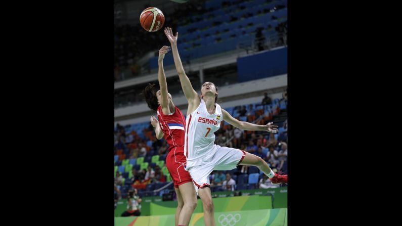 Spain's Alba Torrens, right, shoots over Serbia's Sonja Petrovic during a semifinal game. Spain won 68-54 and will play the United States in the final.