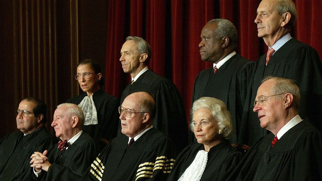 O'Connor takes a photo with the rest of the Supreme Court justices in December 2003. Seated, from left, are Antonin Scalia, John Paul Stevens, Chief Justice William Rehnquist, O'Connor and Anthony Kennedy. Standing, from left, are Ruth Bader Ginsburg, David Souter, Clarence Thomas and Stephen Breyer.