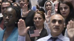 Citizenship candidates take the Oath of Allegiance to the US during a naturalization ceremony on World Refugee Day in recognition of those who have come to the US with refugee or asylum seeker status, at the US Holocaust Memorial Museum on June 20, 2016 in Washington, DC. 