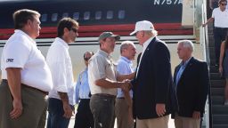 Republican presidential candidate Donald Trump, followed by his running mate, Indiana Gov. Mike Pence, shakes hands with Louisiana Attorney General Jeff Landry as he is greeted by Louisiana officials upon his arrival at the Baton Rouge airport in Baton Rouge, La., Friday, Aug. 19, 2016.