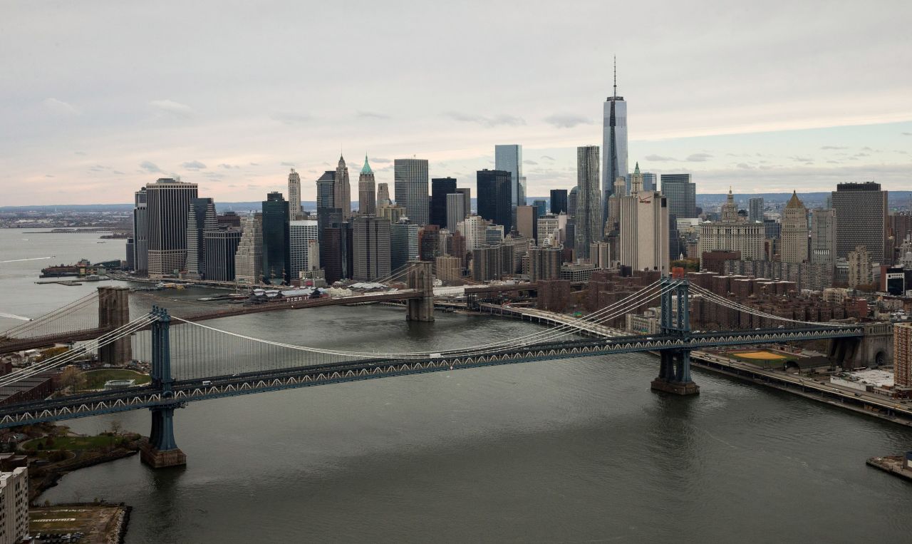 One World Trade Center, the tallest building in the Western Hemisphere, is seen behind the Manhattan and Brooklyn bridges.