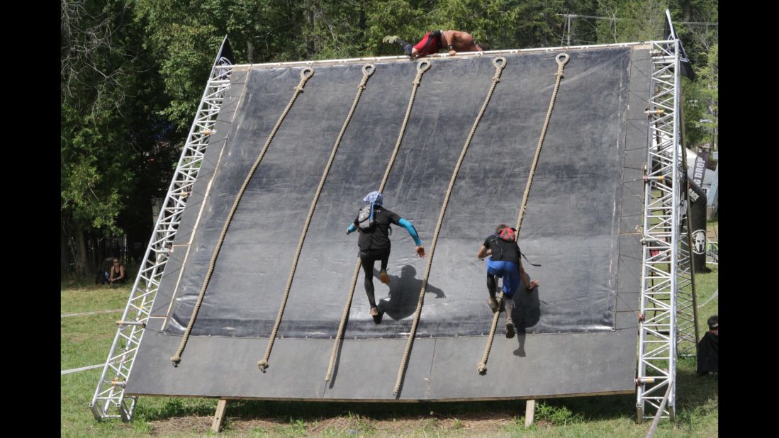 The final obstacle on the course is the Slip Wall. Some runners have enough speed to reach the top without using a rope.