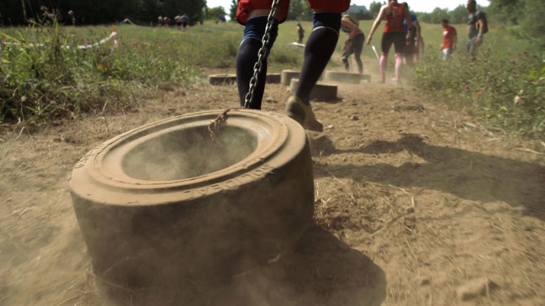 Participants haul tractor tires.