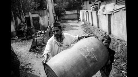 A man rushes with a water drum as a water tanker arrives in Latur, India.